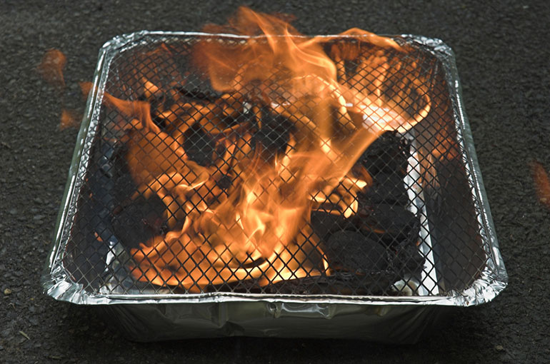 Disposable barbecue on fire