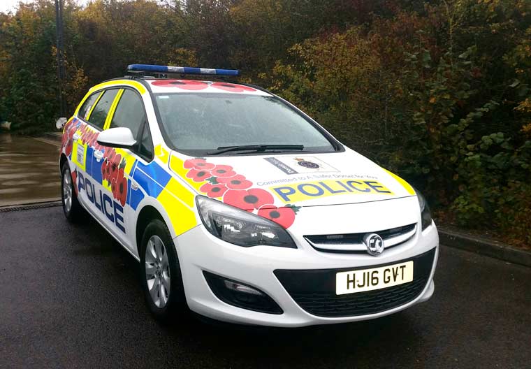 Police car is decorated with poppies in support of Dorset Poppy Appeal