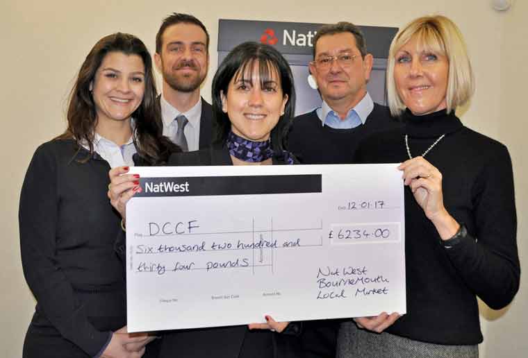 > BANK ON US: NatWest Poole, Parkstone and Canford Cliffs branch manager Lizzie Mayell, centre, with Dorset Cancer Care Foundation's Anne Rowland, right, and, from left, NatWest senior personal banker Taihnee Bernardes, deputy manager Charles Burnett and Dick Rowland, of DCCF
