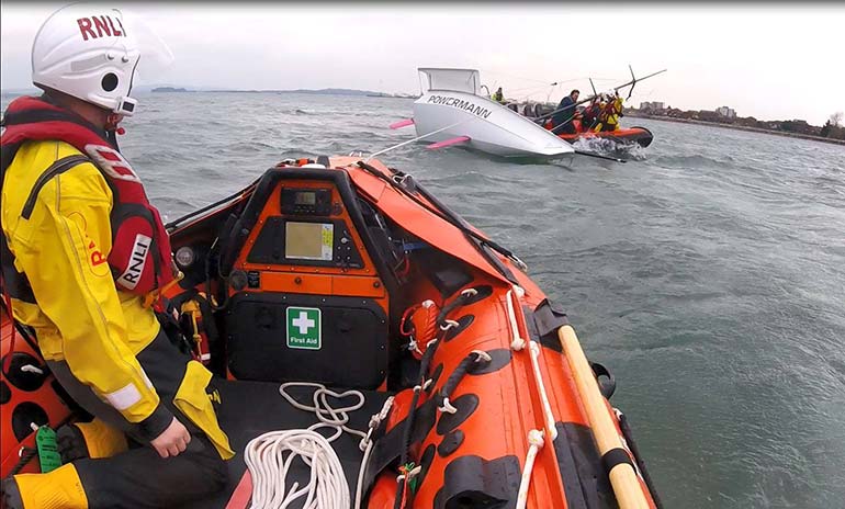 RNLI to the rescue as racing yacht capsizes in Poole Harbour