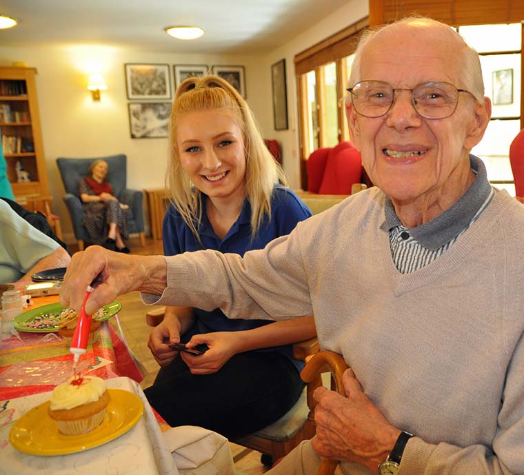 The Aldbury resident Bernard Wickenden shows off one of his sweet creations to student nurse Amelia Barrett