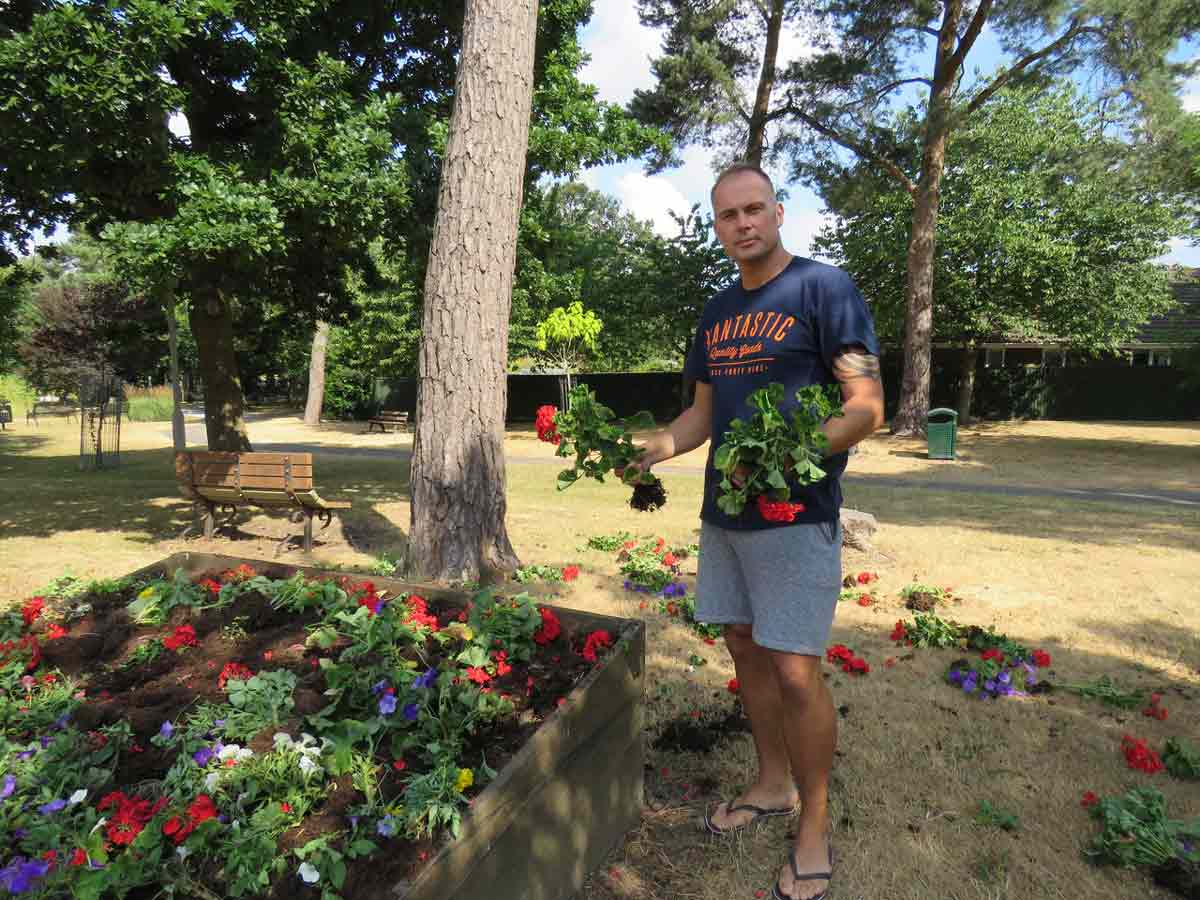 Public spirited Gavin Williams stops in the Millennium Park to help put back some of the plants that were uprooted by vandals