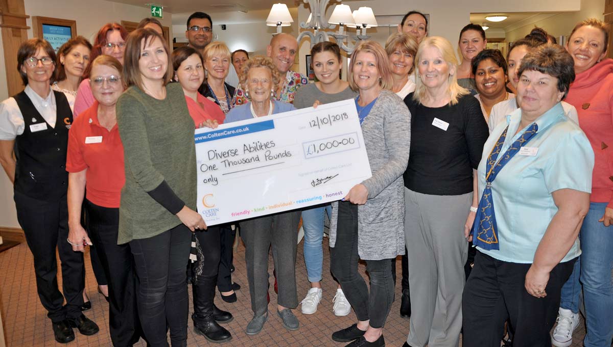 Esme, 100, presents £1,000 cheque to Coping with CHAOS