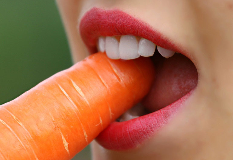 Teeth biting carrot