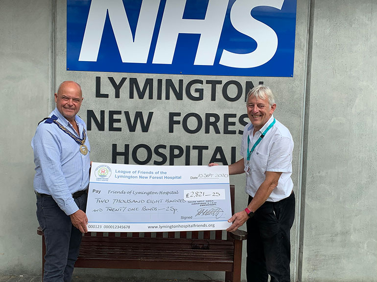 Leon Whitfield from the Freemasons presents the cheque to Arthur English from Lymington Hospital Friends