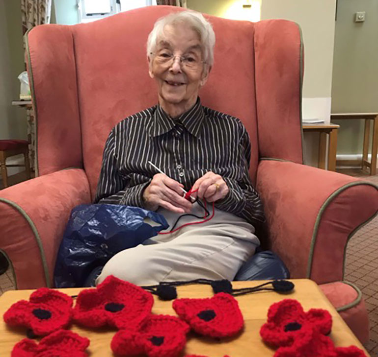 Colten Care resident Maureen Smith, who lives at Whitecliffe House in Blandford, crocheting poppies for the home’s display