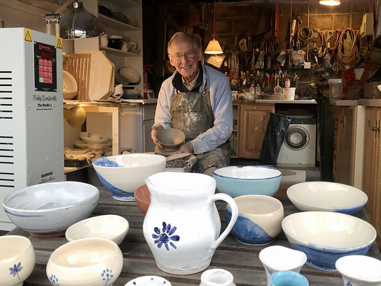 Colin at his potter’s wheel and with some of his work