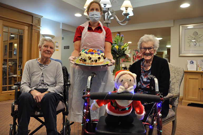 Pam and her Christmas-themed walker, with fellow resident Rosa Leicester and Sarah Harley, companionship team leader