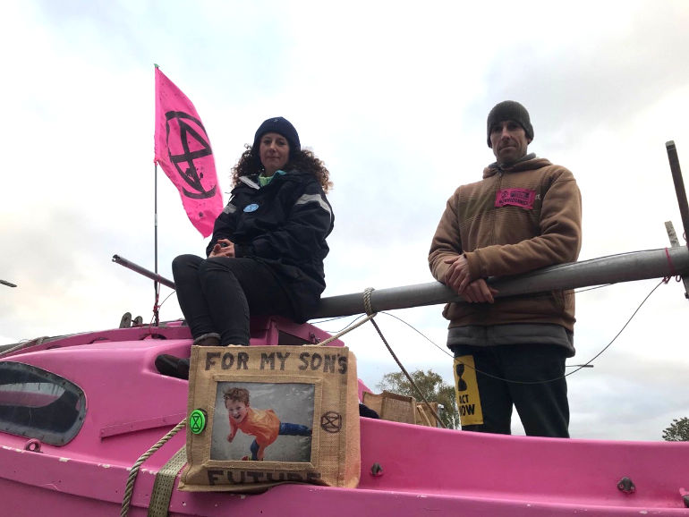Olympians Laura Baldwin and Etienne Stott chained to the pink boat 'The Beverley Geronimo'
