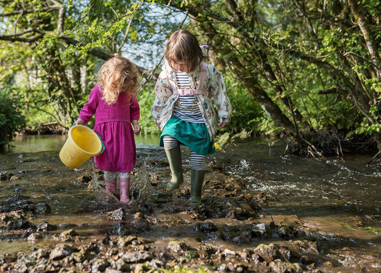 Nature crisis should be tackled alongside the climate emergency say Wildlife Trusts: Image shows children in the River Hooke at the Kingcombe Centre