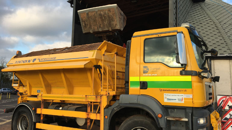 A Dorset Council gritter loading in Charminster