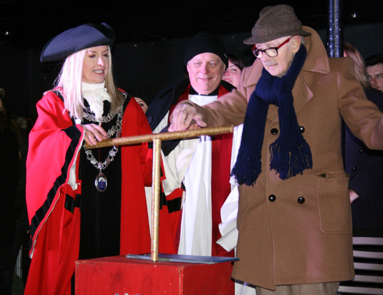 Reg presses the switch, together with the rector of Wimborne Minster, Rev Canon Andrew Rowland, and the Mayor Cllr Kelly Webb