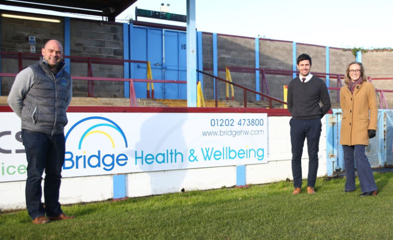 Paul and Louise O'Connell from Bridge Health and Wellbeing with Brian Stock First Team Manager at Weymouth FC