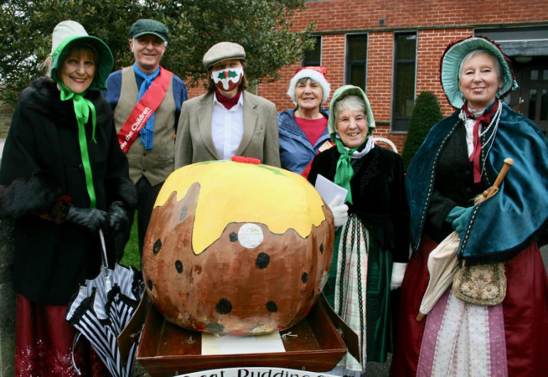 Having taken part in the Great Pudding Stir in the morning, members of the Museum of East Dorset with their giant pudding