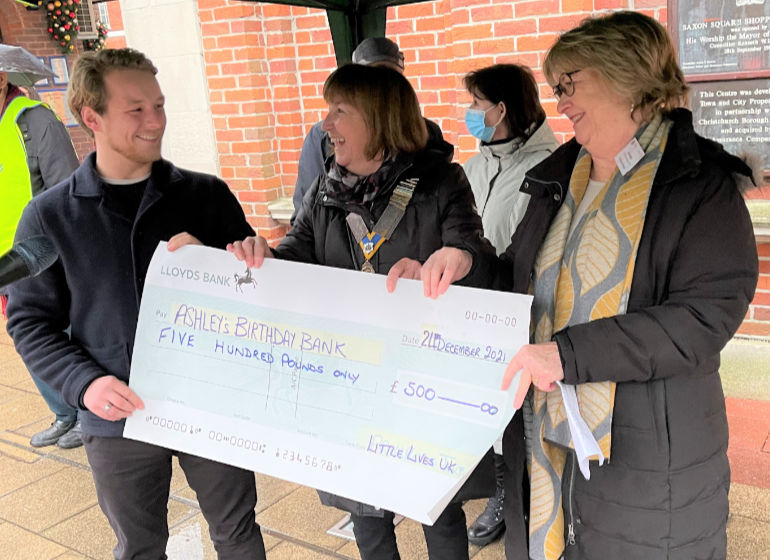 Tom Gillett of Little Lives UK presents the sponsor’s cheque to Marianne Abley and Jan Banks