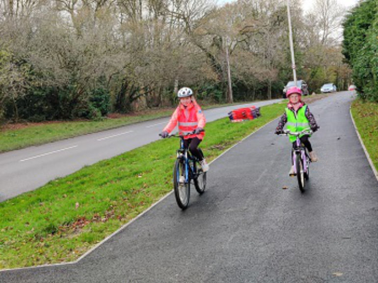 Young cyclists Jess and her sister Abi test out the new cycle lane