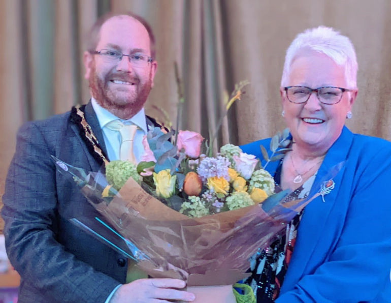 Verwood Mayor, Matthew Parker presents Val Bright with a large bouquet of flowers