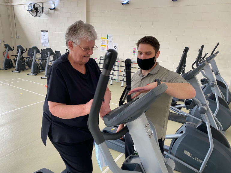 Mary Slade and Sam Panton, exercise duty manager at Bournemouth Heart Club, in the gym