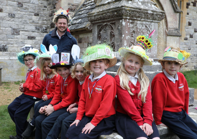 Headteacher Mike Wheeler with some pupils in their bonnets