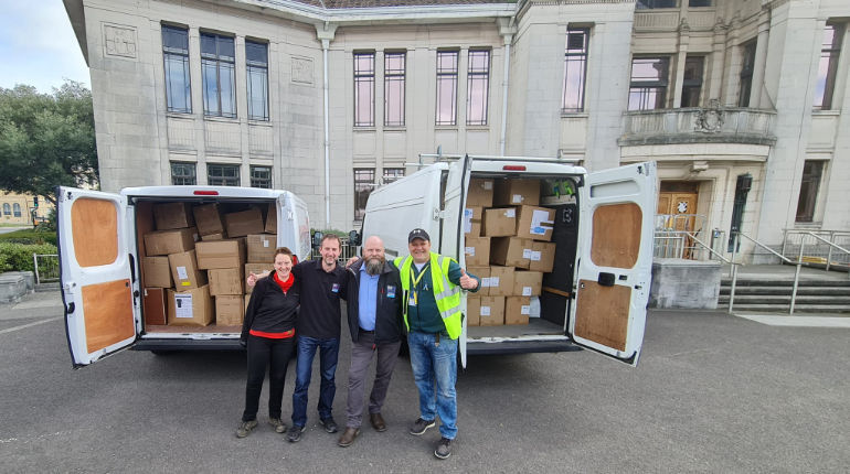 Miles White, BCP Council’s Corporate FM Services Manager, (third from right) with the boxes of PPE set for Ukraine outside Poole Civic Centre