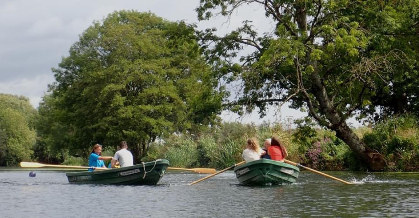 Rowing in the sunshine on the River Stour during Dreamboats Regatta