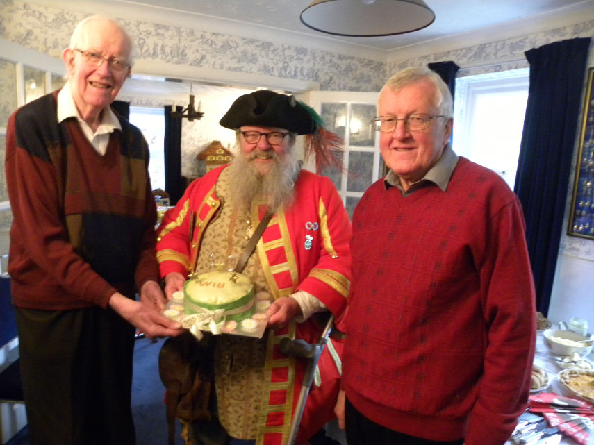 Anthony Oliver with Chris Brown and Richard Nunn, current chairman of Wimborne in Bloom, holding the 30th anniversary cake made by Susie Gatrell. Photo by Christine Oliver