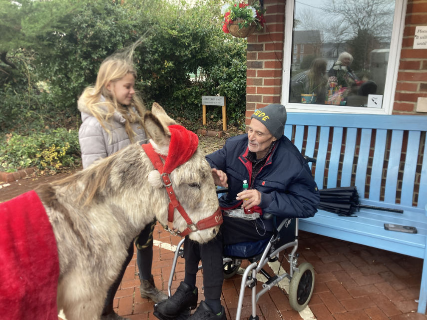 Patient outside Forest Holme greets Charlie the therapy donkey