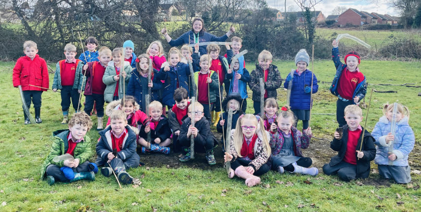 PERFECT PLANTING - Outdoor learning helper Hannah Farmer with some of the children from Verwood Church of England First School and Nursery who have been planting new woodland at their school