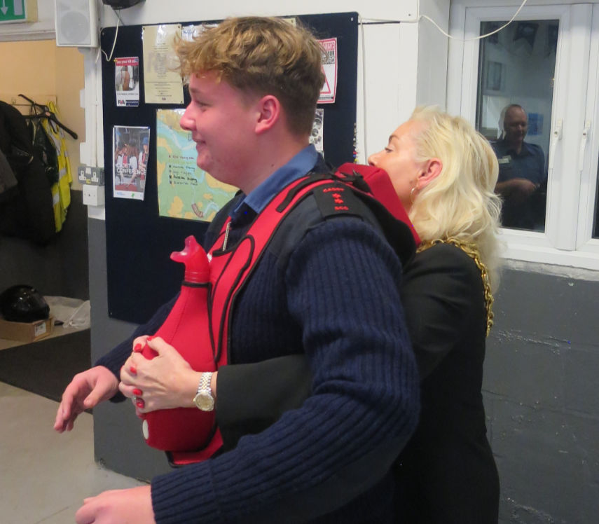 The Mayor practises the Heimlich first aid technique. Photo by Bruce Grant-Braham